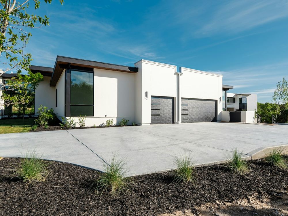 Wide new concrete driveway at a modern house (illustrative photo)