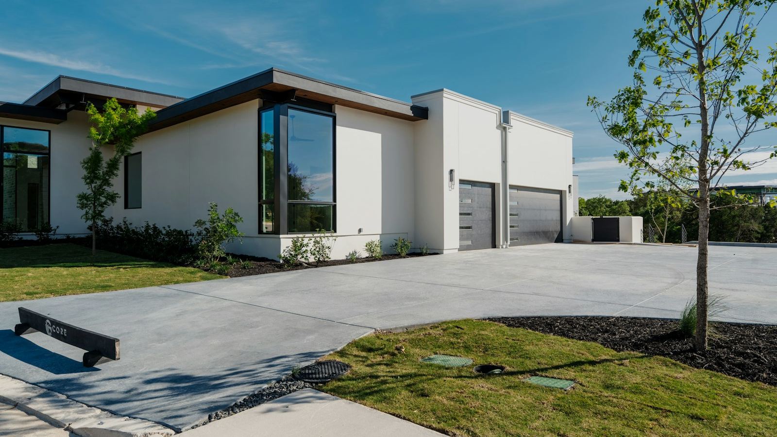 New concrete driveway in front of a modern home (illustrative photo)