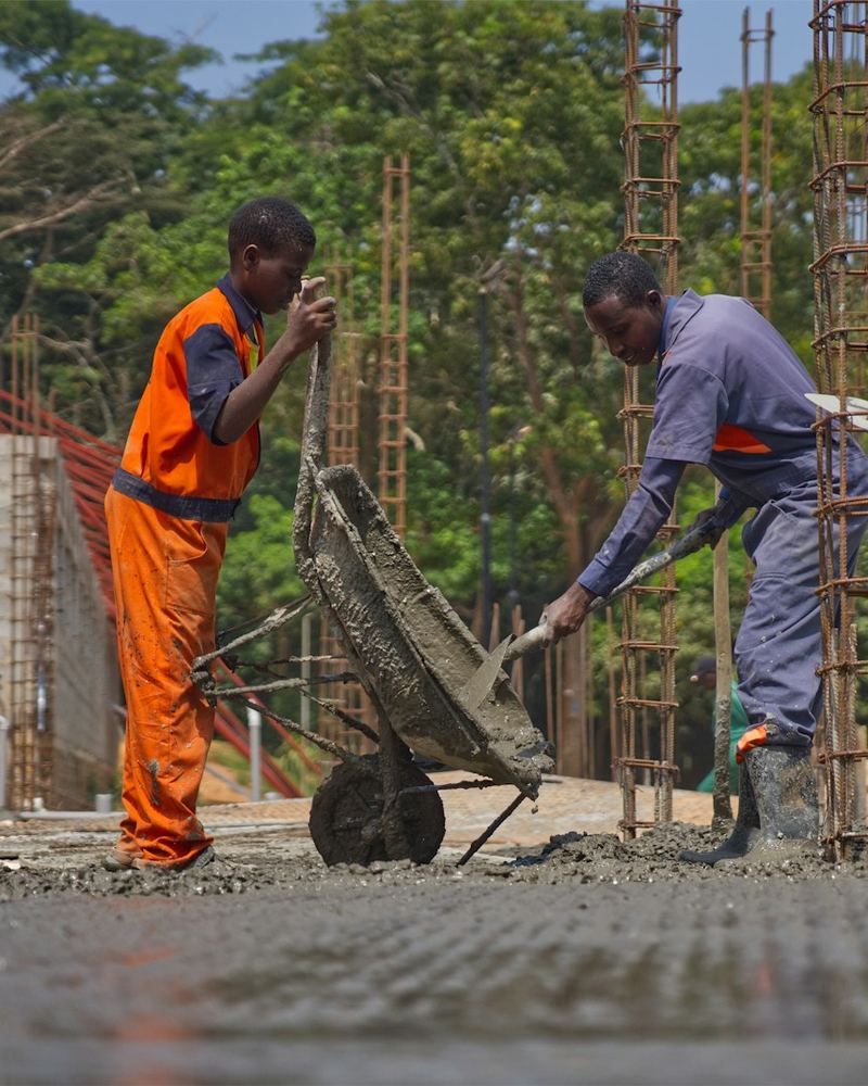 Workers pouring concrete over rebar (illustrative photo)