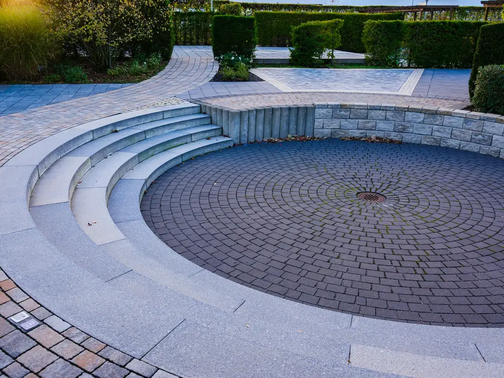 Sunken circular paver court with curved stone steps