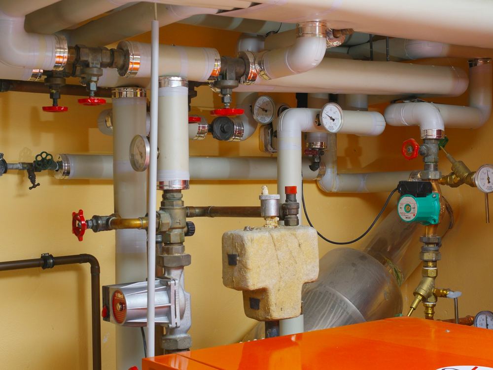Basement mechanical room with copper pipes and valves (illustrative photo)