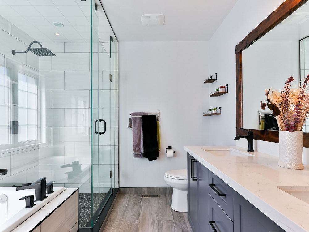 Walk-in glass shower with black fixtures (illustrative photo)