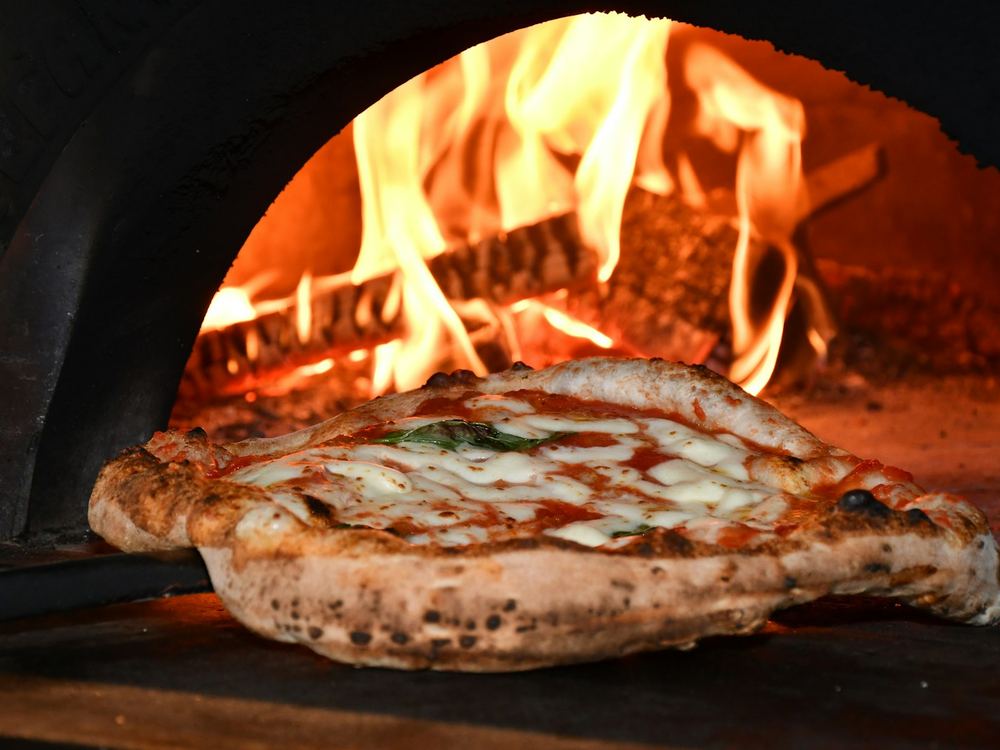 Margherita pizza in a wood-fired oven (illustrative photo)