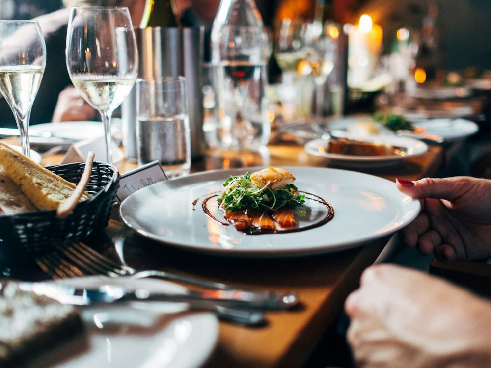 Plated fish dish on a set table (illustrative photo)