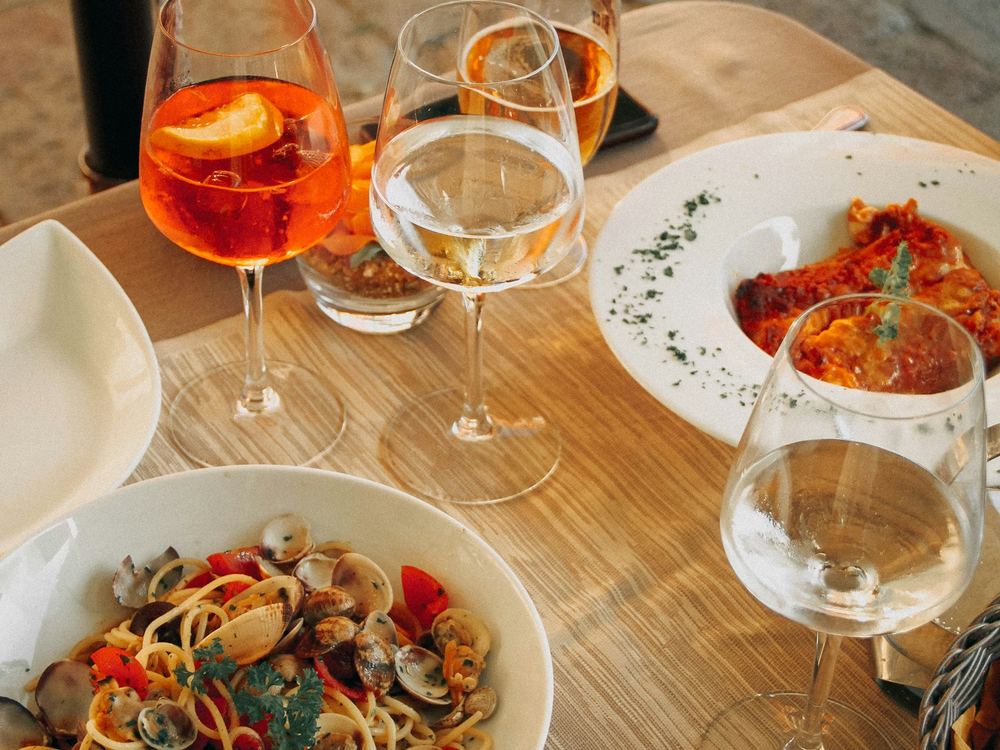 Spaghetti with clams beside a spritz and wine (illustrative photo)