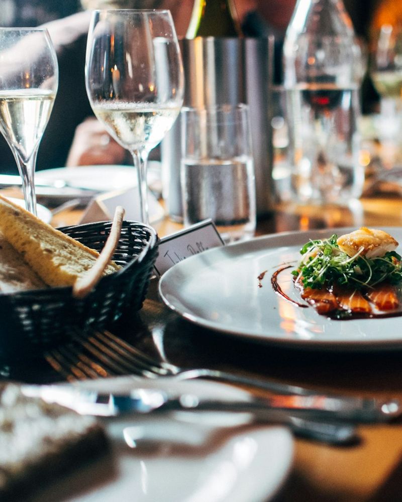 Table set with wine glasses and bread (illustrative photo)