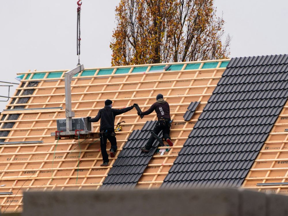 Crew setting roofing over new battens (illustrative photo)