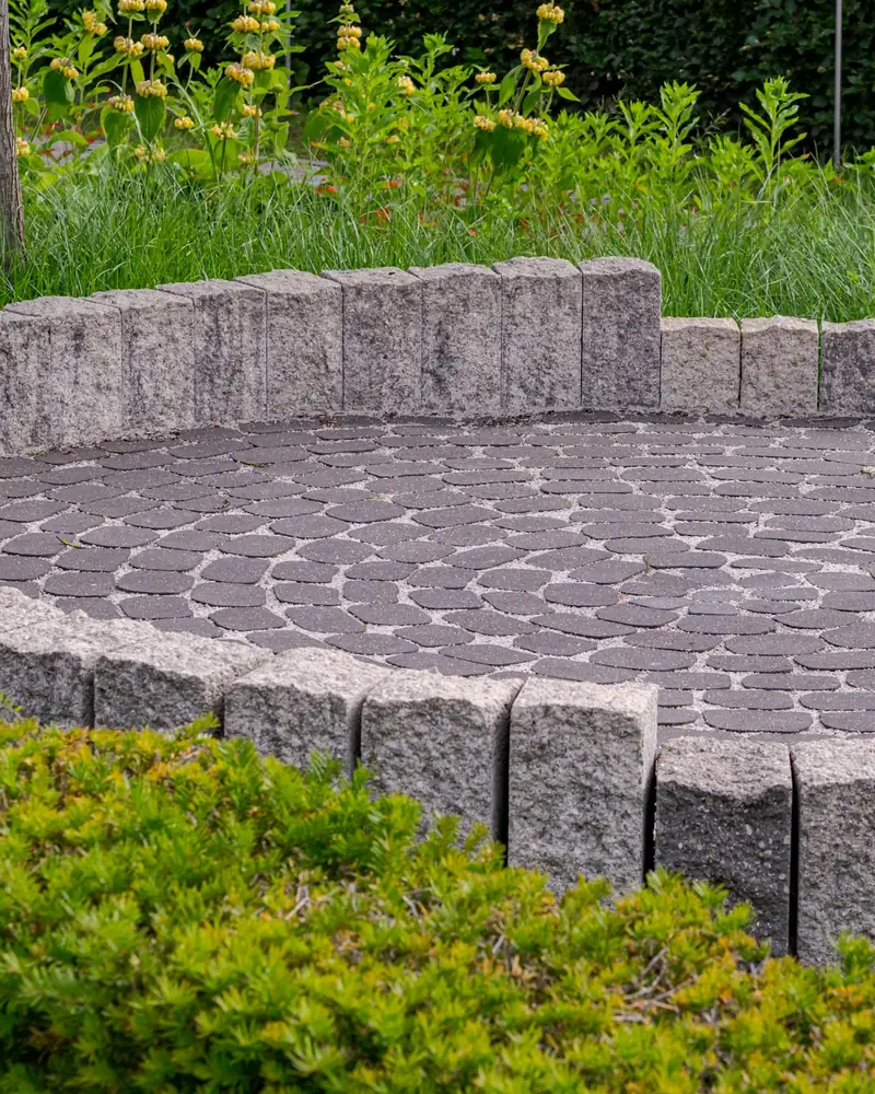 Circular paver patio with low stone edge