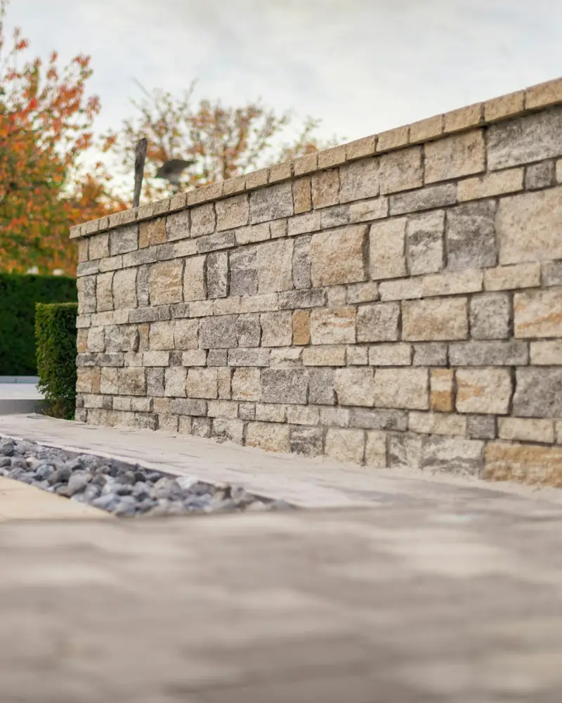 Cut stone wall with autumn trees